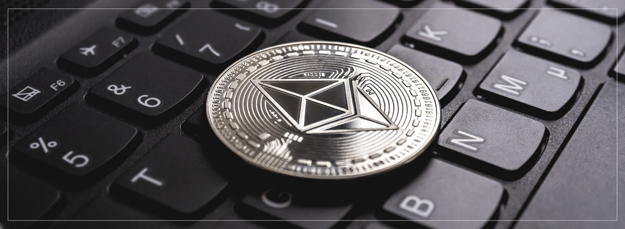 A picture of a computer keyboard with a coin on it