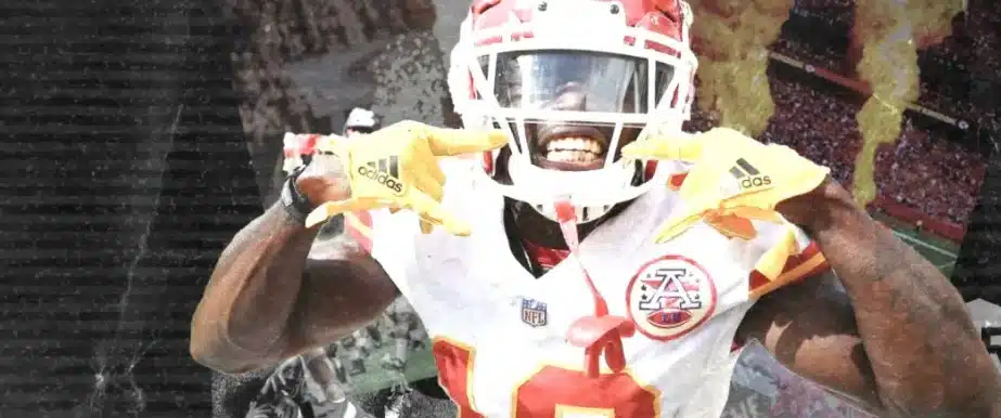 NFL football player celebrating on the field with yellow Adidas gloves – featured in Lucky Rebel online sportsbook and sports betting promotions.