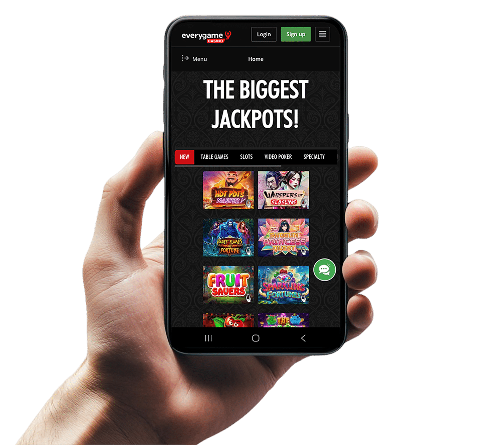 An image of a hand holding a mobile device showing the games page on the Everygame casino website